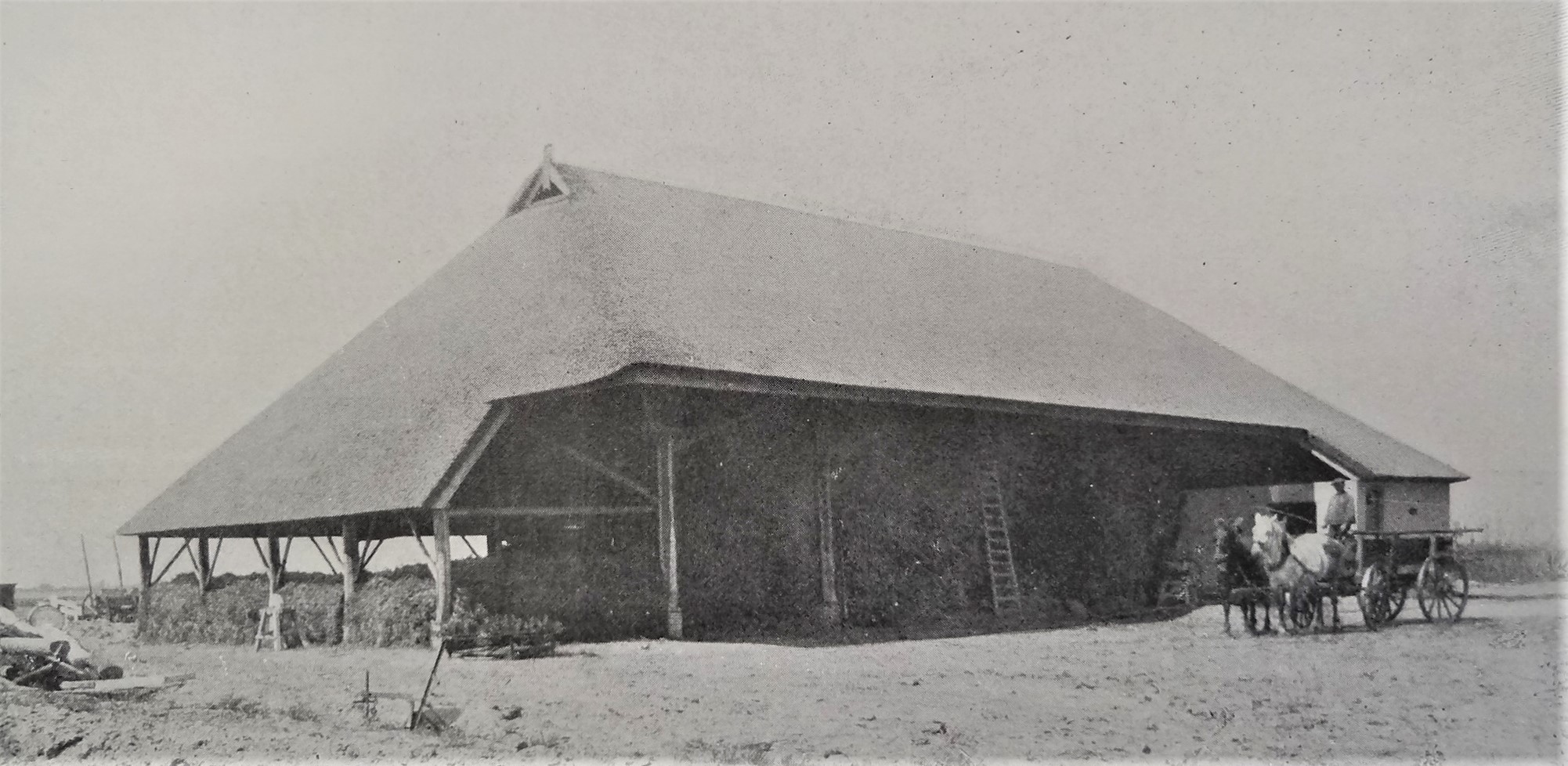 Zwart-witfoto van zicht op het dorp Sprang met de kerk op de achtergrond, omgeven door weilanden en boerderijen, circa 1939-1941.